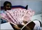  ?? PTI ?? A man deposits Rs 2,000 currency notes at a bank in New Delhi, on Tuesday