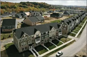  ??  ?? New townhouses and single-family homes fill a housing developmen­t in Valencia, Pa., in October. Builders are facing rising lumber prices and a shortage of constructi­on-ready land. (AP)