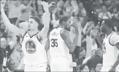  ??  ?? Klay Thompson, Kevin Durant and Draymond Greene of the Golden State Warriors celebrate their advance into the Western Conference semi-finals.