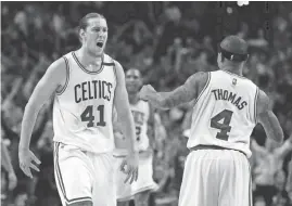  ?? CHARLES KRUPA/AP ?? Celtics center Kelly Olynyk, left, celebrates his basket with guard Isaiah Thomas during the fourth quarter of Game 7 Monday. The two players combined for 55 points.