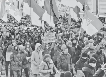  ?? REUTERS ?? People take part in the Unity March, amid growing tensions with Russia, in Kharkiv, Ukraine; Service members of the Ukrainian armed forces (top right) at combat positions outside the settlement of Zaitseve in the Donetsk region, Ukraine.