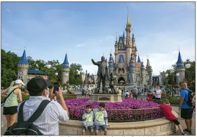  ?? (AP) ?? People visit the Magic Kingdom Park at Walt Disney World Resort in Lake Buena Vista, Fla., in April 2022.