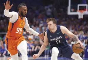  ?? (AFP) ?? Luka Doncic of the Dallas Mavericks handles the ball as Jae Crowder of the Phoenix Suns defends during the second half of Game Four of the 2022 NBA Playoffs Western Conference Semifinals at American Airlines Center in Dallas, Texas, on Sunday.