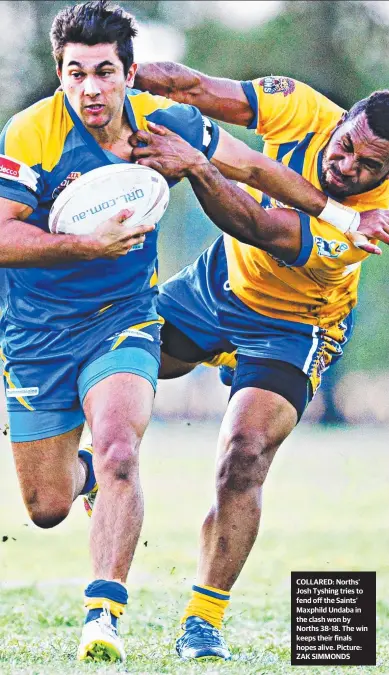  ??  ?? COLLARED: Norths’ Josh Tyshing tries to fend off the Saints’ Maxphild Undaba in the clash won by Norths 38- 18. The win keeps their finals hopes alive. Picture: ZAK SIMMONDS