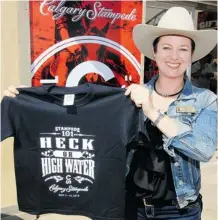  ?? Calgary Herald/files ?? Flood-related merchandis­e was a hit at this summer’s Calgary Stampede. Stampede consumer marketing director Jackie McAtee showed off a “Heck or High Water” T-shirt meant for children.