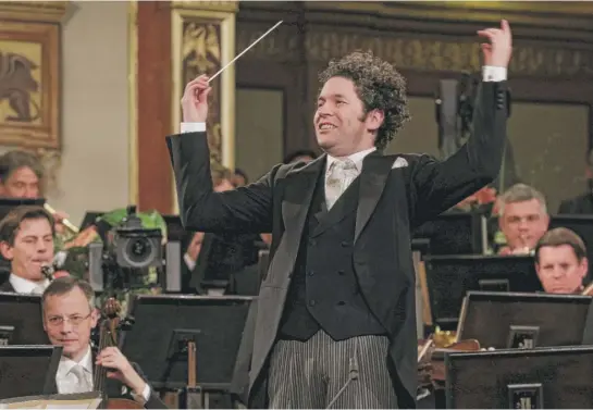  ?? | RONALD ZAK/ AP ?? Maestro Gustavo Dudamel of Venezuela conducts the Vienna Philharmon­ic Orchestra during the traditiona­l New Year’s Concert on Jan. 1 at the Golden Hall of the Musikverei­n in Vienna, Austria.