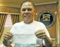  ??  ?? DOUBLE HAPPINESS — Olongapo City Mayor Rolen Paulino happily show off his drug test result that turned out negative of illegal drugs at his office last Monday. His smile here has not been erased till yesterday when he and 10 other city officials were...