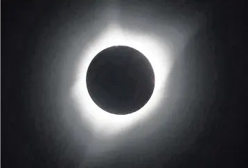  ?? KYLE GREEN Idaho Statesman/TNS ?? The moon transits the sun during the 2017 total solar eclipse as seen from Weiser, Idaho.