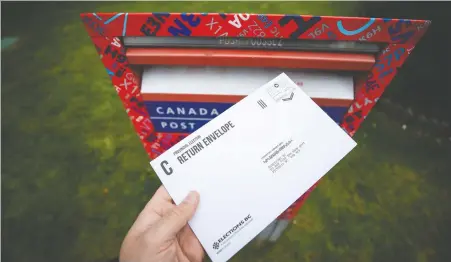  ?? DARRYL DYCK/ THE CANADIAN PRESS ?? With more mail-in ballots than usual being request this year, Elections B.C. is bringing in more staff, but results of Saturday's election may not be known for up to two weeks due to the volume of mailed ballots that will need to be counted.