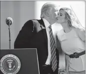  ??  ?? President Donald Trump kisses his daughter Ivanka Trump, right, before speaking about tax reform at the Andeavor Mandan Refinery, on Wednesday