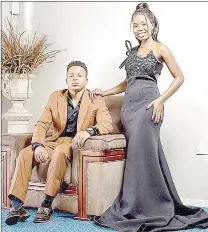  ?? ?? Fanelo Mdluli rocking a brown suit and his partner, Nokwanda Dlamini looked stunning in a one arm black gown.