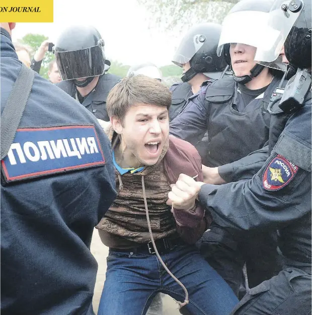  ?? OLGA MALTSEVA/AFP/GETTY IMAGES ?? Russian police arrest a protester in St. Petersburg at an unauthoriz­ed opposition rally, one of several to take place across the country on Monday. Opposition leader Alexei Navalny, who had called for the rallies, was detained and later jailed 15 days...