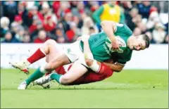  ?? AFP ?? Ireland’s fly-half Johnny Sexton (left) is tackled by Wales’ centre Nick Tompkins during the Six Nations Internatio­nal rugby union match on February 5.