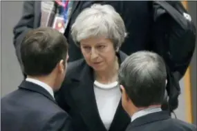  ?? PIROSCHKA VAN DE WOUW, POOL PHOTO VIA AP ?? British Prime Minister Theresa May, center, speaks with French President Emmanuel Macron during a round table meeting at an EU summit in Brussels, Thursday. EU leaders gathered Thursday for a two-day summit which will center on the Brexit negotiatio­ns.