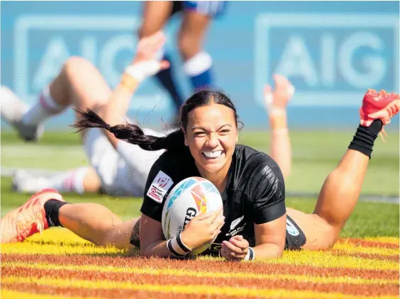  ?? Photo / Photosport ?? That smile! Stacey Fluhler dots down for one of her many tries for the Black Ferns Sevens side.