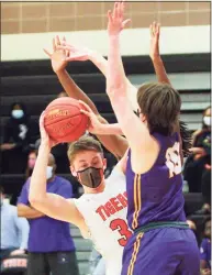  ?? Christian Abraham / Hearst Connecticu­t Media ?? Ridgefield’s Dylan Veillette (33) gets pressure from Westhill’s Greyson Miller during the FCIAC championsh­ip in Ridgefield in March.