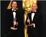  ??  ?? Alan Barillaro, left, and Marc Sondheimer pose in the press room with the award for best animated short film for ‘Piper’.