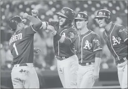  ?? PAUL SANCYA — ASSOCIATED PRESS ?? Jed Lowrie, second from left, celebrates hitting a grand slam against the Tigers.