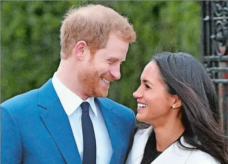  ?? DOMINIC LIPINSKI/PA VIA AP ?? Britain’s Prince Harry and Meghan Markle smile as they pose for the media Monday on the grounds of Kensington Palace in London. Prince Harry, fifth in line for the British throne, will marry American actress Meghan Markle in the spring.