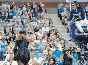  ?? CHANG W. LEE THE NEW YORK TIMES ?? American Serena Williams argues with Carlos Ramos, the chair umpire, during the U.S. Open final against Naomi Osaka of Japan at Arthur Ashe Stadium in New York on Saturday.