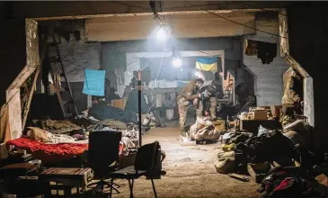  ?? DMYTRO KOZATSKI/AZOV SPECIAL FORCES REGIMENT OF THE UKRAINIAN NATIONAL GUARD PRESS OFFICE VIA AP ?? Ukrainian soldiers shelter May 7 inside the ruined Azovstal steel plant in Mariupol, Ukraine. For nearly three months, Azovstal’s garrison hung on, refusing to be forced out from the tunnels and bunkers under the ruins of the labyrinthi­ne mill.