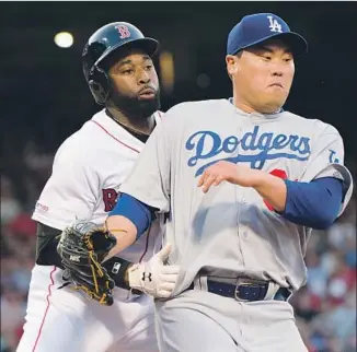  ?? Kathryn Riley Getty Images ?? DODGERS pitcher Hyun-Jin Ryu collides with Jackie Bradley Jr. of the Red Sox in the second inning of Sunday’s game. Ryu pitched seven innings of two-run ball but did not get a decision.