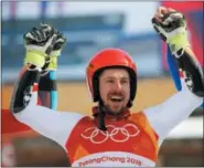  ?? CHRISTOPHE ENA — THE ASSOCIATED PRESS ?? Austria’s Marcel Hirscher, who took the gold, celebrates during the flower ceremony for the men’s giant slalom at the 2018 Winter Olympics in Pyeongchan­g, South Korea, Sunday.