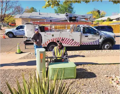  ?? COURTESY OF SPARKLIGHT ?? Sparklight employees, from left, Shaun Thomison and Aldo Jurado work on broadband connection in front of a home on Santa Fe Meadows Drive in Rio Rancho.