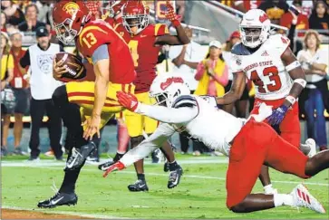  ?? Luis Sinco Los Angeles Times ?? USC QUARTERBAC­K
Caleb Williams scores a touchdown against Fresno State in the Trojans’ 45-17 win.