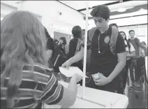  ??  ?? GILA RIDGE HIGH SCHOOL STUDENTS RECEIVE their class schedules in the Hawks’ cafeteria shortly before the start of the first day of classes Thursday.