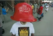  ?? GARY LANDERS — THE ASSOCIATED PRESS ?? Robert Morris, of Jasper, Tenn., wears a giant hat as he waits in line to enter a rally by President Donald Trump Thursday in Cincinnati.