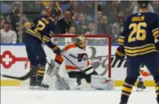 ?? JEFFREY T. BARNES — THE ASSOCIATED PRESS ?? Alex Lyon’s 2018 Flyers debut was a short and forgettabl­e one, as he allowed four first-period goals, including this one to Buffalo’s Tage Thompson, in a 5-2 loss to the Sabres Wednesday night.