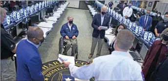  ?? — AFP photo ?? Biden and Texas Governor Greg Abbott (centre) listen to officials at the Harris County Emergency Operations Center in Houston, Texas.