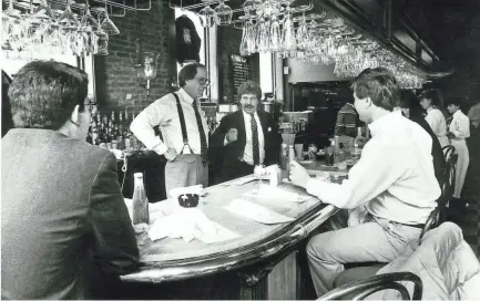  ?? THE COMMERCIAL APPEAL ?? Former Channel 3 reporter Earle Farrell (wearing suspenders) presides over Sleep Out Louie's bar in this 1988 file photo.