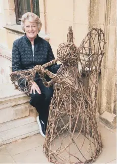  ??  ?? Victoria Leatham with one of the wicker angels at Thorpe Hall Photo: Tim Sandall