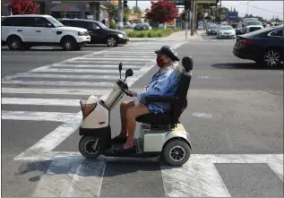  ?? ARIC CRABB — STAFF ARCHIVES ?? A woman uses an electric scooter to cross the intersecti­on of Monterey Road and Curtner Avenue in San Jose in 2021.