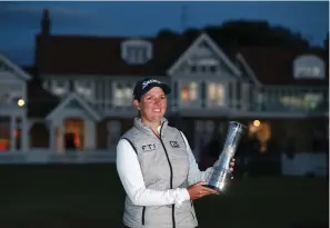  ?? The Associated Press ?? South Africa’s Ashleigh Buhai celebrates after winning the Women’s British Open during the presentati­on ceremony Sunday in Muirfield, Scotland.