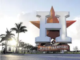  ?? Karen Warren / Staff photograph­er ?? It’s difficult to look at the logo and championsh­ip banner at the entrance to the Astros facility in the same way this year due to the sign-stealing scandal.