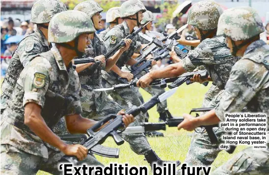  ??  ?? People’s Liberation Army soldiers take part in a performanc­e during an open day of Stonecutte­rs Island naval base, in Hong Kong yesterday.