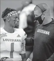  ?? Todd Kirkland/Getty Images/TNS ?? In this photo from 2020, Levi Lewis (1) of the LouisianaL­afayette Ragin Cajuns speaks to head coach Billy Napier in the second half of the game against the Georgia State Panthers at Center Parc Stadium in Atlanta.