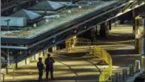  ?? THE ASSOCIATED PRESS ?? Police stand guard in front of Port Authority Bus Terminal following an explosion near New York’s Times Square on Monday. Police said a man with a pipe bomb strapped to him set off the crude device in an undergroun­d passageway under 42nd Street between...