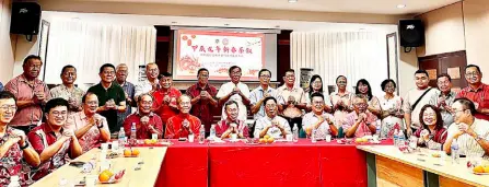  ?? ?? Dr Sim (seated, centre) and Lau, on his left, join other VIPs and guests in a photo-call at the ‘New Year Tea Party for the Year of the Dragon’ at Wisma Huawen Du Zhong, Sibu.