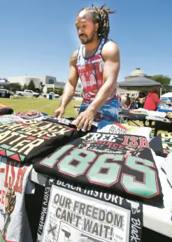  ?? ?? Travis Morris puts out some of his many T-shirts during the festival Saturday.