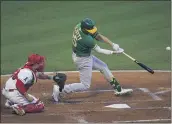  ?? JAE C. HONG — THE ASSOCIATED PRESS ?? The A’s Stephen Piscotty hits an RBI single during the second inning Monday against the Angels in Anaheim.
