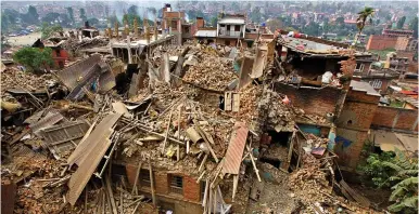  ??  ?? Disaster: Homes have been reduced to piles of rubble in Bhaktapur near the capital Kathmandu