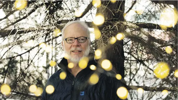  ?? DAVID BLOOM ?? Small lights are visible hanging in a tree as University of Alberta naturalist John Acorn discusses loss of firefly habitat.