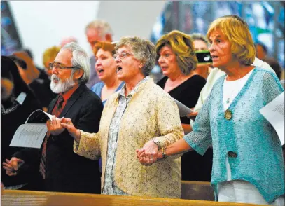  ??  ?? People attending an interfaith service at Guardian Angel Cathedral on Sunday pay tribute to the memory of the victims.