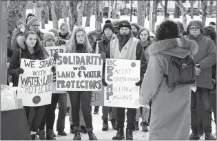  ?? BARB SWEET/THE TELEGRAM ?? Lydia Halley and Isabella Lacey in Bannerman Park Sunday at a peaceful rally to protest the arrest of 14 Indigenous land defenders and elders in We’suwet’en territory in the interior of British Columbia. The arrests were made earlier this month at a blockade of a forest service road in northern B.C. preventing access to the proposed LNG pipeline project.