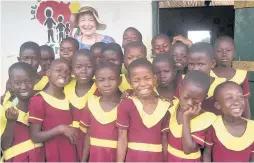  ??  ?? Vital work Mary with some of the pupils at the Let Us Shine School in