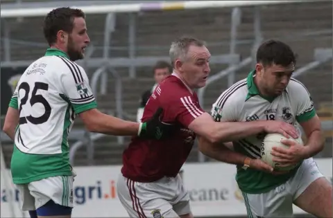  ??  ?? Colm Morris of Castletown challenges Mark Molloy (St. James’) as Greg Doyle awaits developmen­ts.